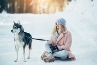 vecteezy_beautiful-girl-with-dog-husky-in-snowy-woods_11341876_647